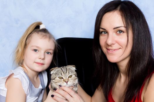 Image of mother, daughter and grey kitty