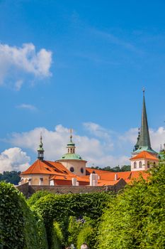 Cityscape of Prague in summer. Trees, leaves, sky