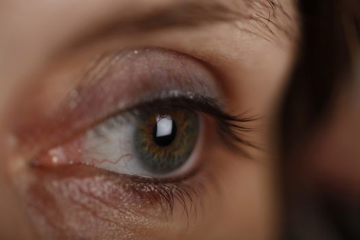 Close up photo of an green woman's eye