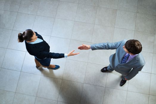 image of a businessmen stretching out their hands towards each other, the future handshake