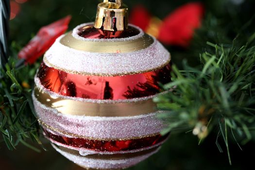 Close up of Christmas ornaments on tree.