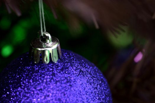 Close up of Christmas ornaments on tree.