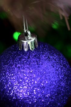 Close up of Christmas ornaments on tree.