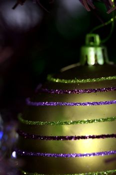 Close up of Christmas ornaments on tree.