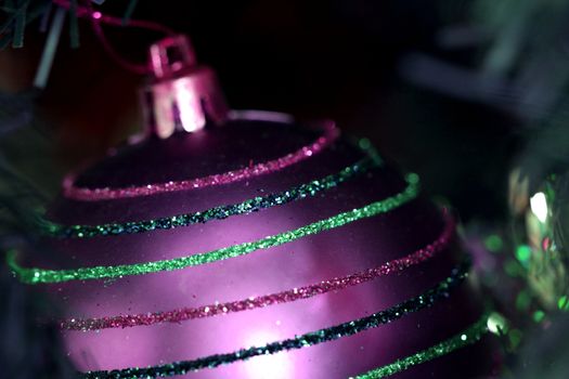 Close up of Christmas ornaments on tree.