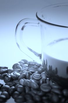 Cup with coffee, costing on coffee grain.