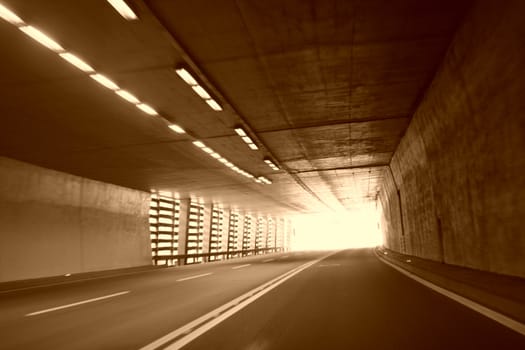 Car lights trails in a tunnel