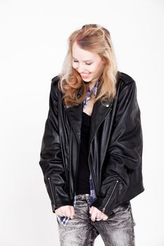Young tough blond teenage girl with leather jacket on a white background