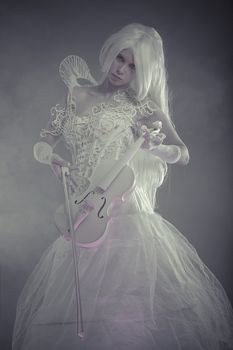 Music concept. Beautiful model with long white hair and vintage corset