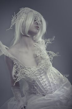 Fantasy. Beautiful model with long white hair and vintage corset