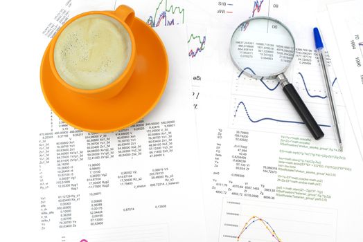 Cup of coffee, business objects and paper with graphs. Business concept