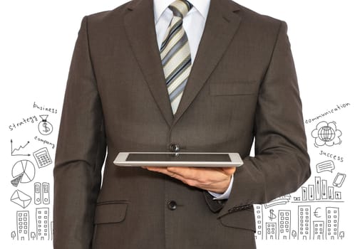 Businessman with a tablet in hand and business sketches. Business concept