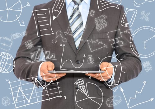 Businessman with a tablet in hands and business sketches. Business concept