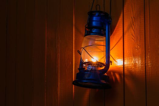 The old kerosene lantern hanging on the yellow wooden wall