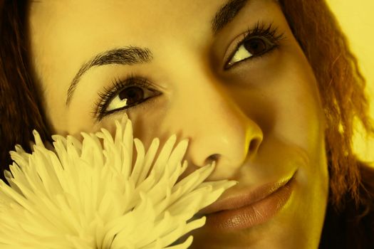 Macro image of a girl face with a white flower