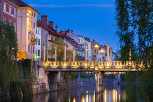 Romantic medieval Ljubljana's city center, the capital of Slovenia, Europe. Gallus bank of river Ljubljanica with Cobblers' Bridge or the Shoemakers' Bridge ( ��evljarski or ��u��tarski most ) shot at dusk.