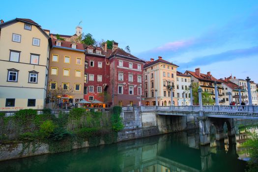 Romantic medieval Ljubljana's city center, the capital of Slovenia, Europe. Gallus bank of river Ljubljanica with Cobblers' Bridge or the Shoemakers' Bridge ( ��evljarski or ��u��tarski most ) shot at dusk.