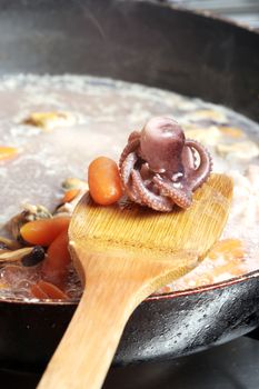 Seafood cooked with vegetables in a pan.