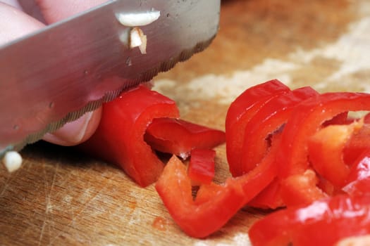 Cutting pepper into small slices.
