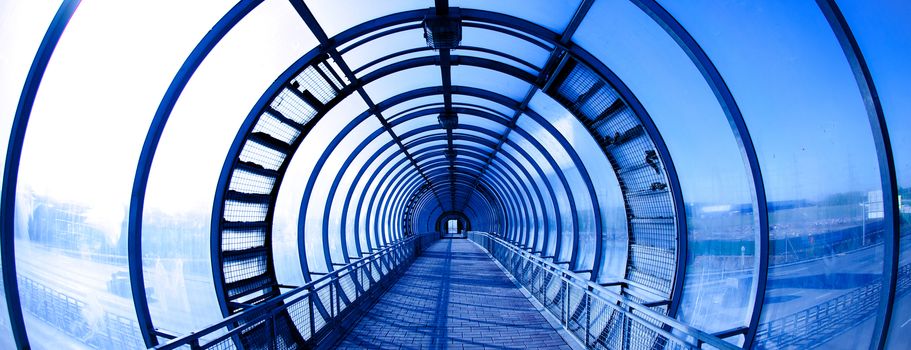 Interior blue glass tunnel, city public construction