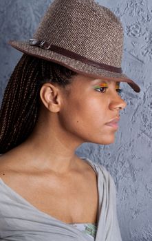 profile portrait of yong woman in a hat