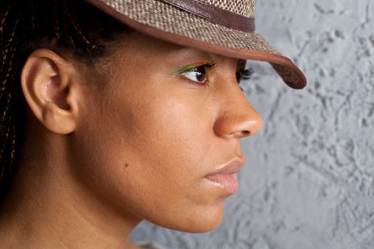 profile portrait of a black girl in hat
