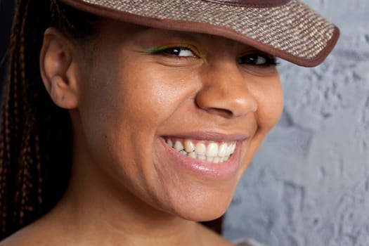 portrait of a smiling young woman in hat
