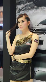 BANGKOK, THAILAND - MARCH 30, 2014: Unidentified female presenter pose in the 35th Bangkok International Motor Show on March 30, 2014 in Nonthaburi, Thailand.