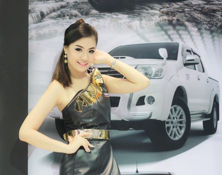 BANGKOK, THAILAND - MARCH 30, 2014: Unidentified female presenter pose in the 35th Bangkok International Motor Show on March 30, 2014 in Nonthaburi, Thailand.