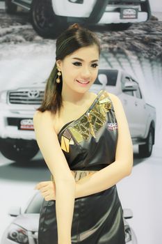 BANGKOK, THAILAND - MARCH 30, 2014: Unidentified female presenter pose in the 35th Bangkok International Motor Show on March 30, 2014 in Nonthaburi, Thailand.