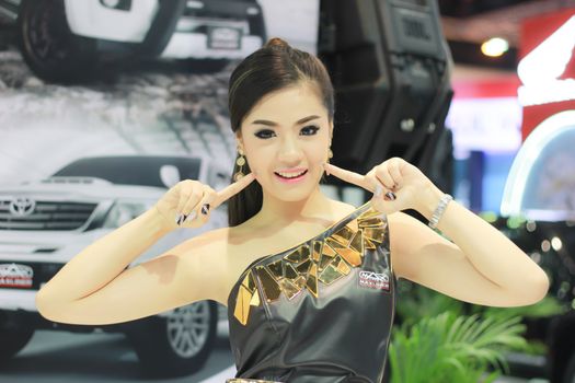 BANGKOK, THAILAND - MARCH 30, 2014: Unidentified female presenter pose in the 35th Bangkok International Motor Show on March 30, 2014 in Nonthaburi, Thailand.