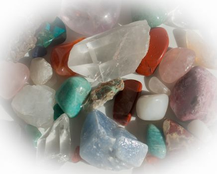 Heap of semi-precious stones - aventurine, quartz, calcite, turquoise, rhodochrosite, rose quartz and more.