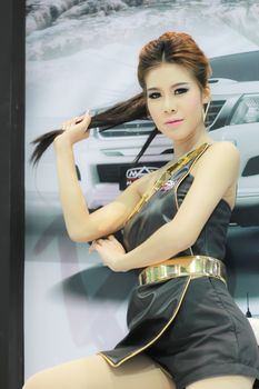 BANGKOK, THAILAND - MARCH 30, 2014: Unidentified female presenter pose in the 35th Bangkok International Motor Show on March 30, 2014 in Nonthaburi, Thailand.