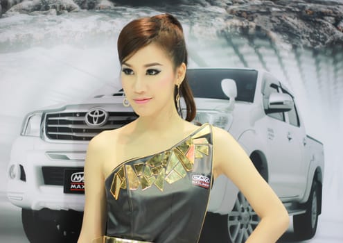 BANGKOK, THAILAND - MARCH 30, 2014: Unidentified female presenter pose in the 35th Bangkok International Motor Show on March 30, 2014 in Nonthaburi, Thailand.