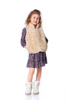 A beautiful young girl dressed for winter, over a white background