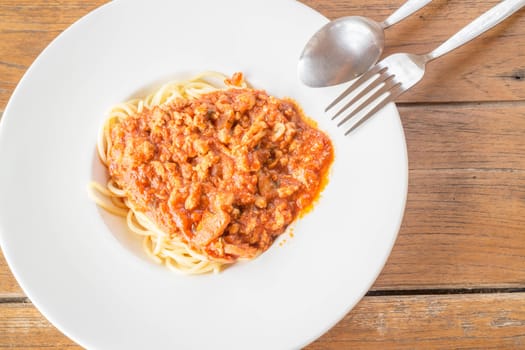 Pasta with tomato sauce on wooden table, stock photo