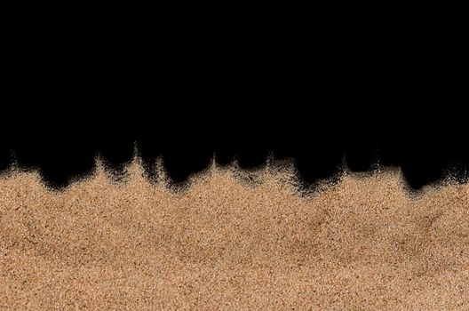 The sand on the black background close-up