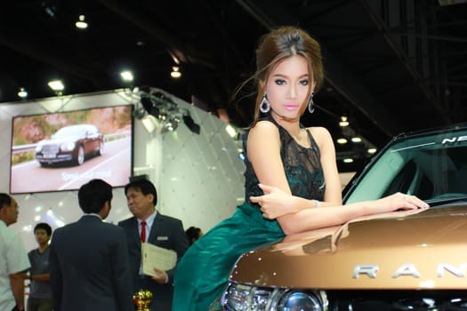 BANGKOK, THAILAND - MARCH 30, 2014: Unidentified female presenter pose in the 35th Bangkok International Motor Show on March 30, 2014 in Bangkok, Thailand.