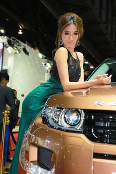 BANGKOK, THAILAND - MARCH 30, 2014: Unidentified female presenter pose in the 35th Bangkok International Motor Show on March 30, 2014 in Bangkok, Thailand.