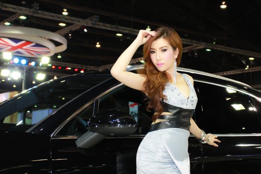 BANGKOK, THAILAND - MARCH 30, 2014: Unidentified female presenter pose in the 35th Bangkok International Motor Show on March 30, 2014 in Bangkok, Thailand.