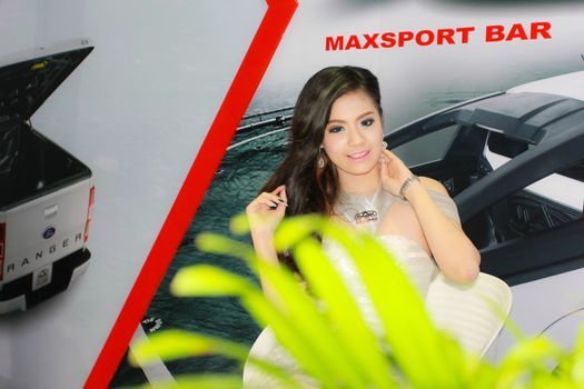 BANGKOK, THAILAND - MARCH 30, 2014: Unidentified female presenter pose in the 35th Bangkok International Motor Show on March 30, 2014 in Bangkok, Thailand.