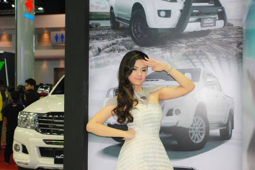 BANGKOK, THAILAND - MARCH 30, 2014: Unidentified female presenter pose in the 35th Bangkok International Motor Show on March 30, 2014 in Bangkok, Thailand.