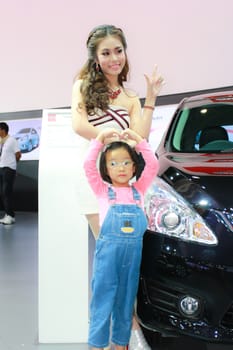 BANGKOK, THAILAND - MARCH 30, 2014: Unidentified female presenter pose in the 35th Bangkok International Motor Show on March 30, 2014 in Bangkok, Thailand.