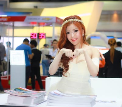 BANGKOK, THAILAND - MARCH 30, 2014: Unidentified female presenter pose in the 35th Bangkok International Motor Show on March 30, 2014 in Bangkok, Thailand.