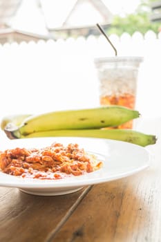 Spaghetti tomato pork sauce with fruit and drink, stock photo