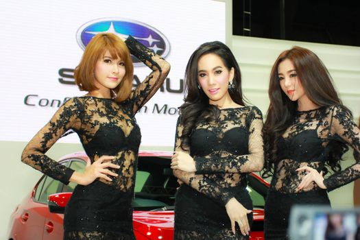BANGKOK, THAILAND - MARCH 30, 2014: Unidentified female presenter pose in the 35th Bangkok International Motor Show on March 30, 2014 in Bangkok, Thailand.