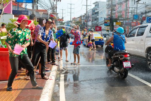 Phuket, Thailand - April 13, 2014: Tourist and residents celebrate Songkran Festival, the Thai New Year by splashing water to each others on Patong streets. 