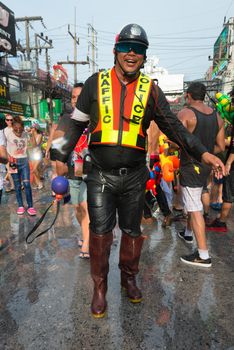 Phuket, Thailand - April 13, 2014: Police officercelebrate Songkran Festival, the Thai New Year by splashing water to each others on Patong streets. 