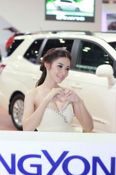 BANGKOK, THAILAND - MARCH 30, 2014: Unidentified female presenter pose in the 35th Bangkok International Motor Show on March 30, 2014 in Nonthaburi, Thailand.