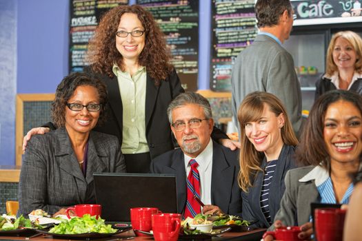 Happy diverse group of business people meeting for lunch